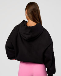 Woman wearing CFT BNE 26 Unisex Oversized Hoodie - Black-Candy Pink | Model:Brylee | Size:XS