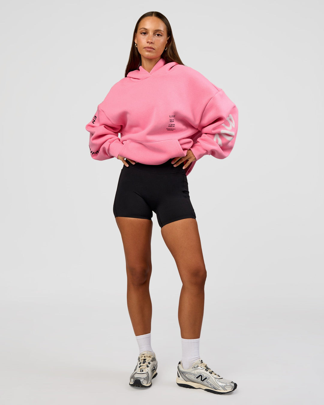 Woman wearing CFT BNE 26 Unisex Oversized Hoodie - Candy Pink-Black | Model:Brylee | Size:XS