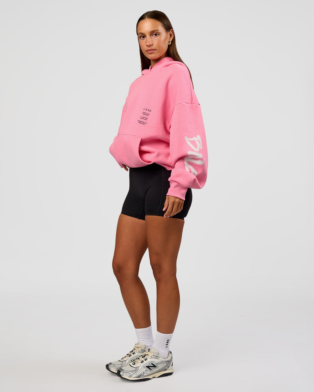 Woman wearing CFT BNE 26 Unisex Oversized Hoodie - Candy Pink-Black | Model:Brylee | Size:XS
