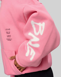 Woman wearing CFT BNE 26 Unisex Oversized Hoodie - Candy Pink-Black | Model:Brylee | Size:XS