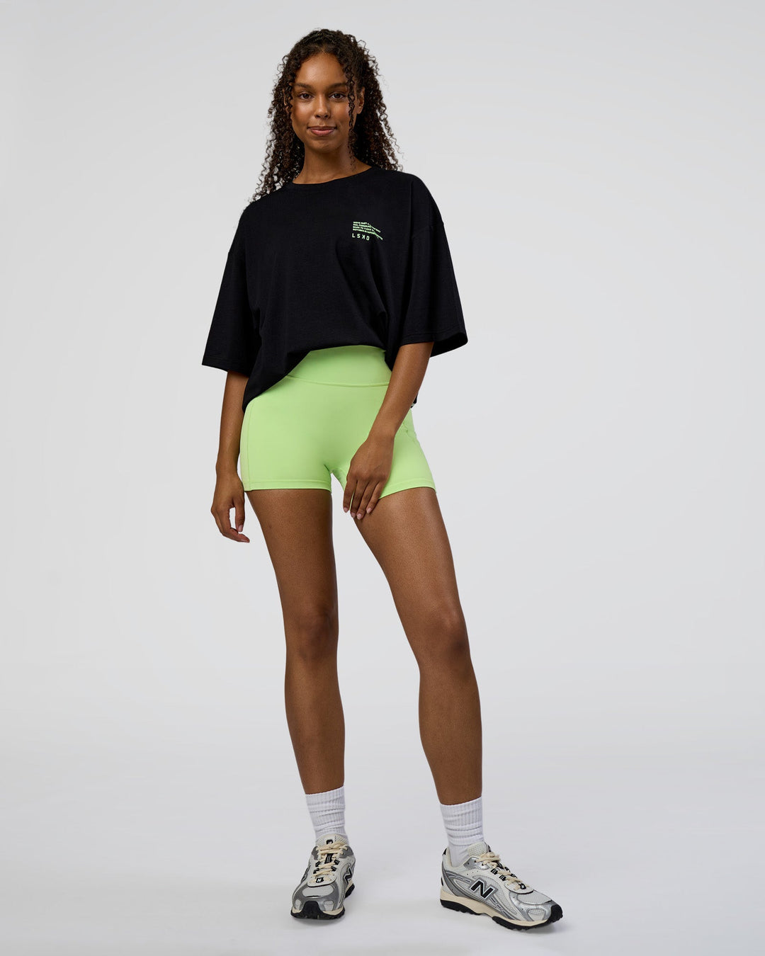 Woman wearing Coffee Run FLXCotton Oversized Tee - Black-Solar Lime | Model:Jordan | Size:XS