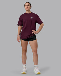 Woman wearing Coffee Run FLXCotton Oversized Tee - Cherry Lacquer-Black | Model:Sav | Size:XS