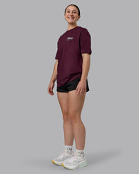 Woman wearing Coffee Run FLXCotton Oversized Tee - Cherry Lacquer-Black | Model:Sav | Size:XS