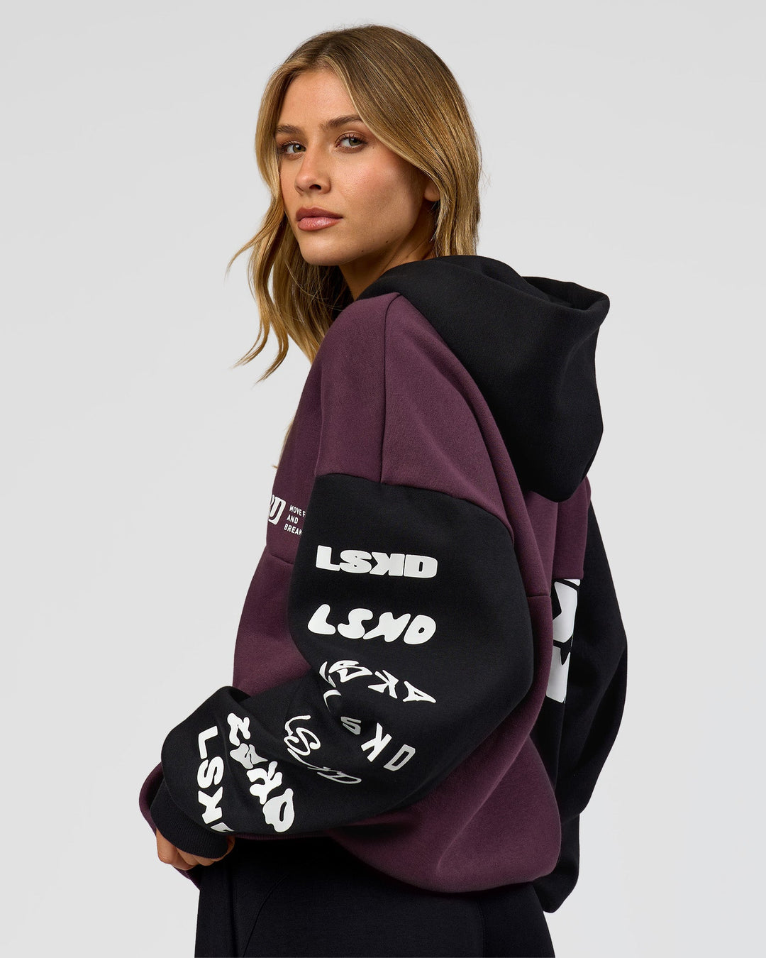 Woman wearing Deconstructed Fleece Hoodie - Caviar-Midnight Plum | Model:Leilani | Size:XS
