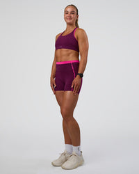 Woman wearing Distinction Sports Bra 2.0 - Plum Caspia-Ultra Pink | Model:Sav | Size:XS