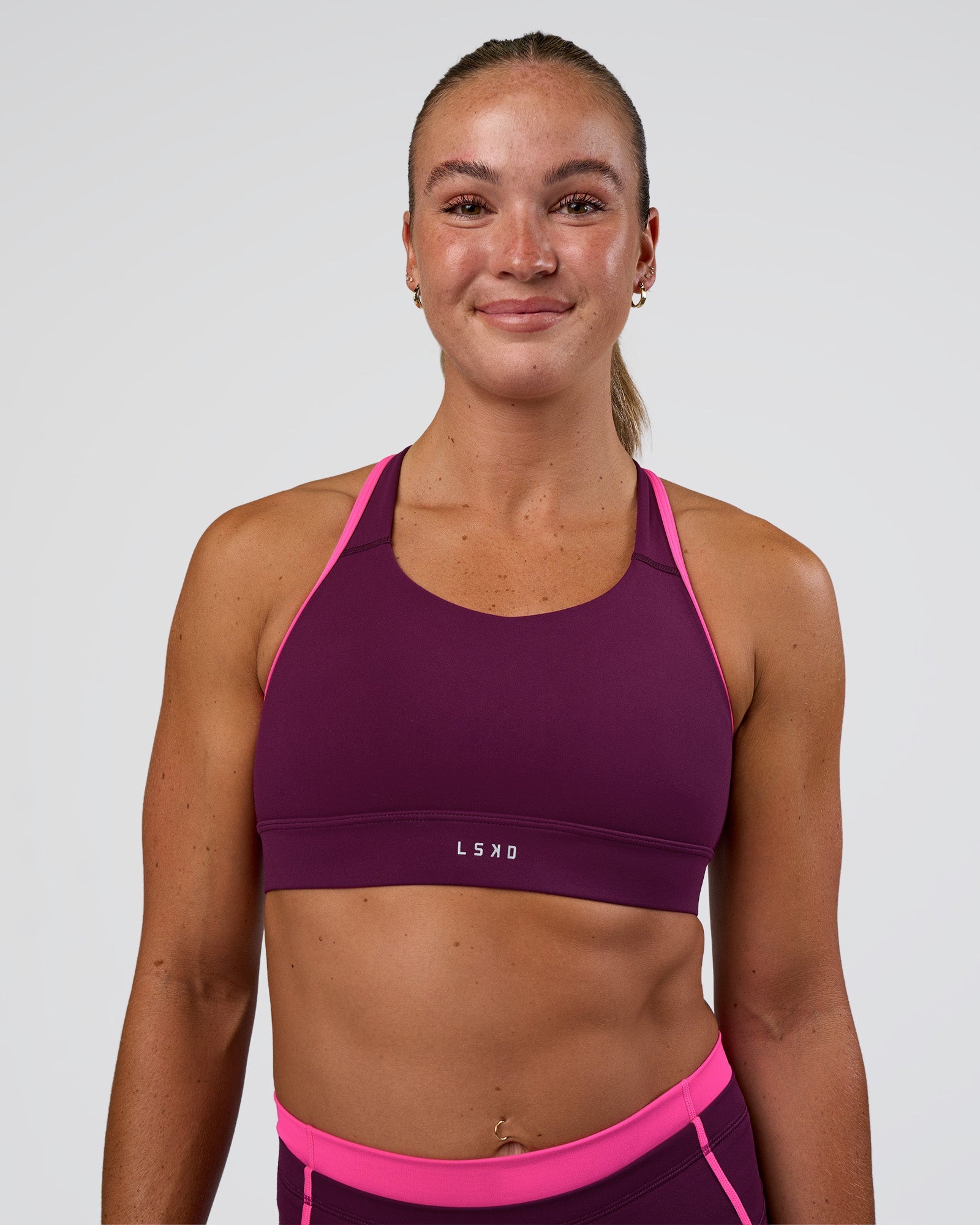 Woman wearing Distinction Sports Bra 2.0 - Plum Caspia-Ultra Pink | Model:Sav | Size:XS