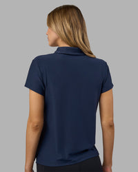 Woman wearing Drive Polo - Future Navy | Model:Leilani | Size:XS