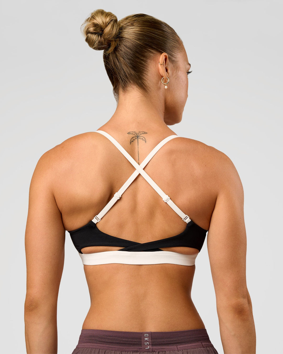 Man wearing Elevate Sports Bra - Black-Multi | Model:Maja | Size:XS