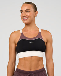 Woman wearing Elevated Accelerate Sports Bra - Black-Multi | Model:Maja | Size:XS