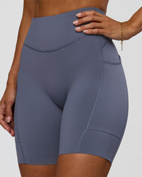 Woman wearing Elite Run High-Rise 7" Short Pockets - Night Shadow | Model:Brylee | Size:XS