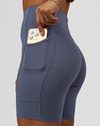 Woman wearing Elite Run High-Rise 7" Short Pockets - Night Shadow | Model:Brylee | Size:XS