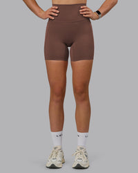 Woman wearing Elixir Ultra High-Rise 6" Short Pockets - Chocolate Martini | Model:Chloe | Size:XS