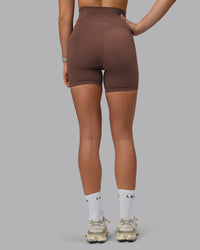 Woman wearing Elixir Ultra High-Rise 6" Short Pockets - Chocolate Martini | Model:Chloe | Size:XS