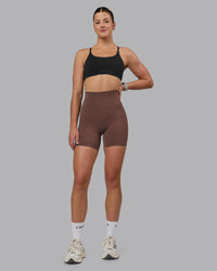 Woman wearing Elixir Ultra High-Rise 6" Short Pockets - Chocolate Martini | Model:Chloe | Size:XS