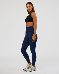 Woman wearing Elixir Ultra High-Rise Full Length Legging Pockets - Future Navy | Model:Brylee | Size:XS