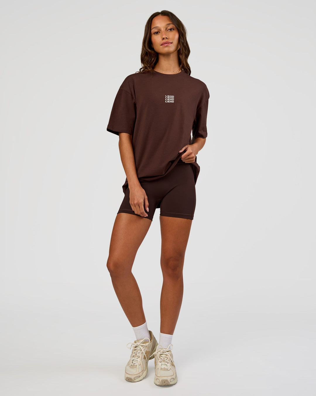 Woman wearing Everyday Elevation FLXCotton Oversized Tee - Hot Chocolate-Off White | Model:Dakota | Size:XS