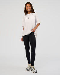 Woman wearing Everyday Elevation FLXCotton Oversized Tee - White-Carbon Green | Model:Dakota | Size:XS