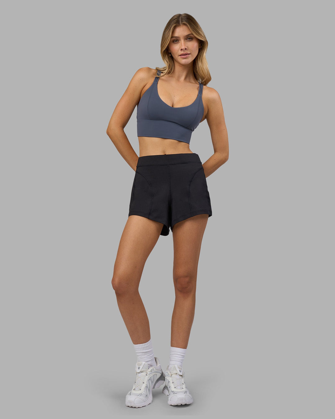 Woman wearing Flash Longline Sports Bra - Night Shadow | Model:Leilani | Size:XS