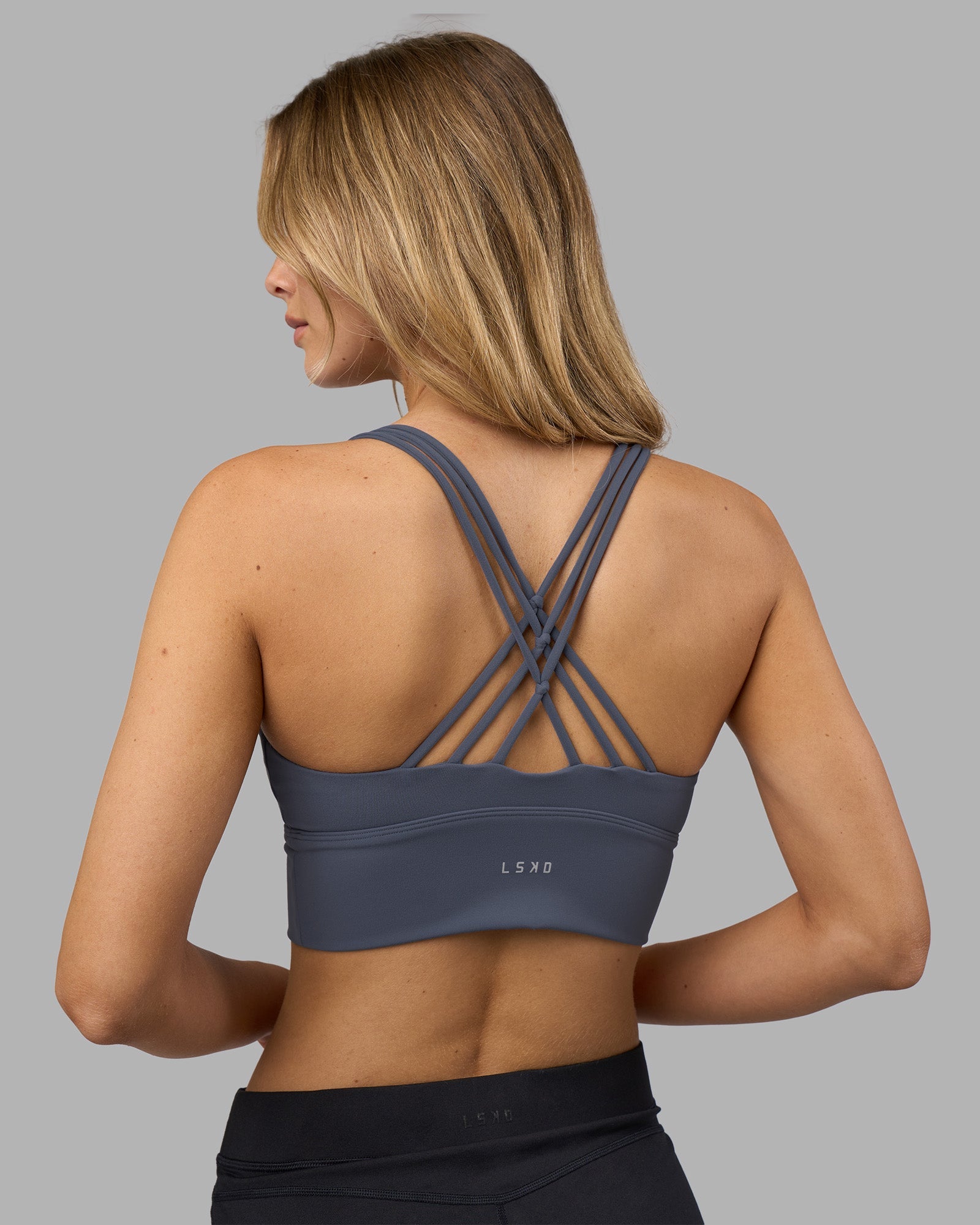 Woman wearing Flash Longline Sports Bra - Night Shadow | Model:Leilani | Size:XS
