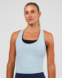 Woman wearing Flow Scoop Neck Performance Tank - Blue Aura | Model:Emelia | Size:XS | Thumbnail Index: 0