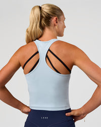 Woman wearing Flow Scoop Neck Performance Tank - Blue Aura | Model:Emelia | Size:XS