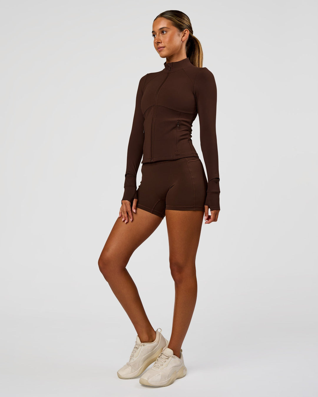Woman wearing Fusion Active Jacket - Hot Chocolate | Model:Charli | Size:XS