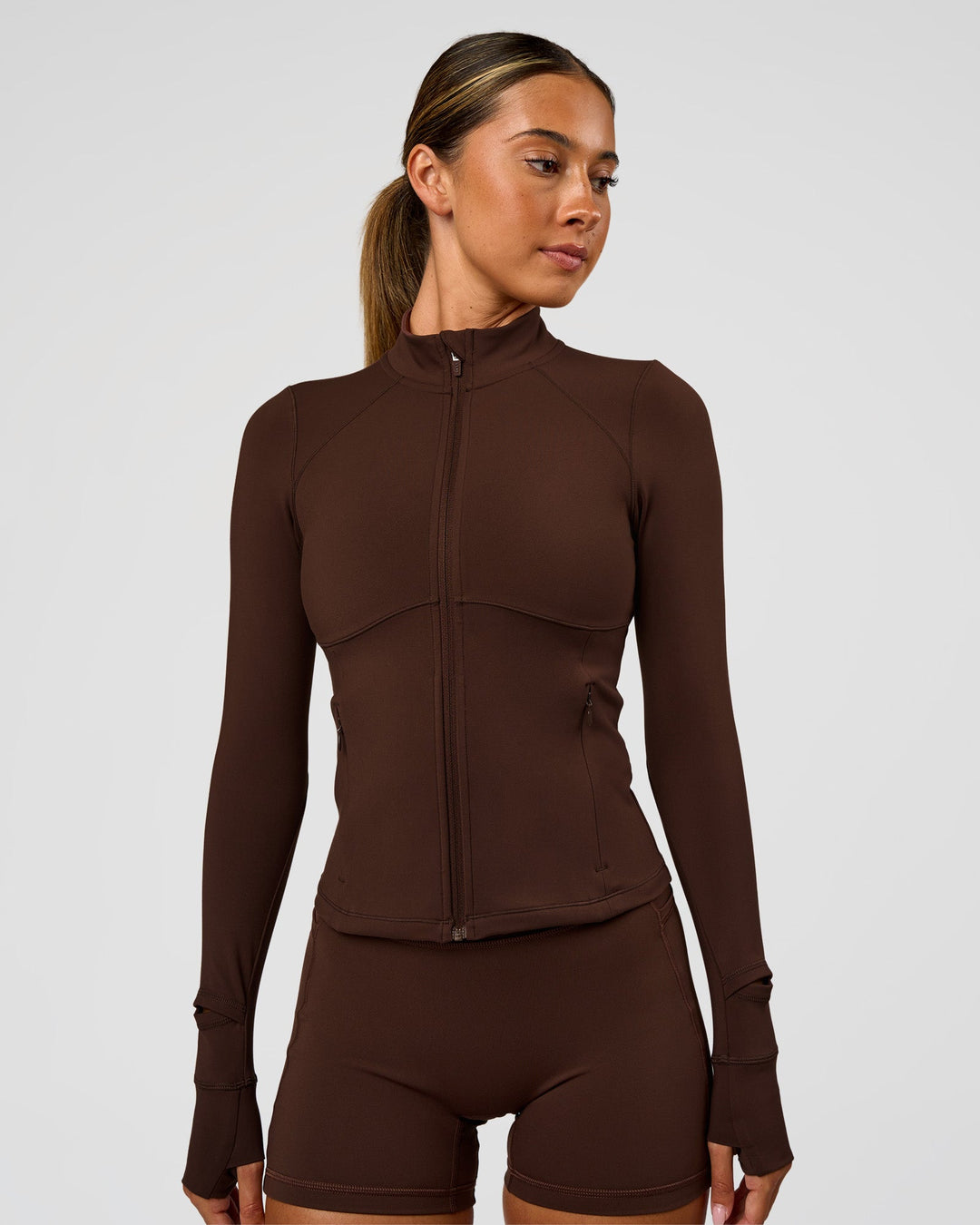 Woman wearing Fusion Active Jacket - Hot Chocolate | Model:Charli | Size:XS