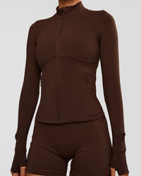 Woman wearing Fusion Active Jacket - Hot Chocolate | Model:Charli | Size:XS
