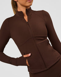 Woman wearing Fusion Active Jacket - Hot Chocolate | Model:Charli | Size:XS