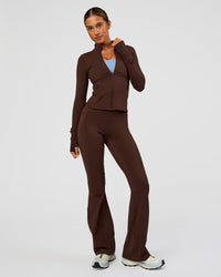 Woman wearing Fusion Active Jacket - Hot Chocolate | Model:Charli | Size:XS