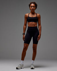 Woman wearing Fusion Ultra High-Rise 9" Short Pockets - Black | Model:Txai | Size:XS