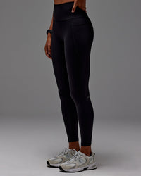 Woman wearing Fusion Ultra High-Rise Full Length Legging Pockets - Black | Model: Txai | Size:XS