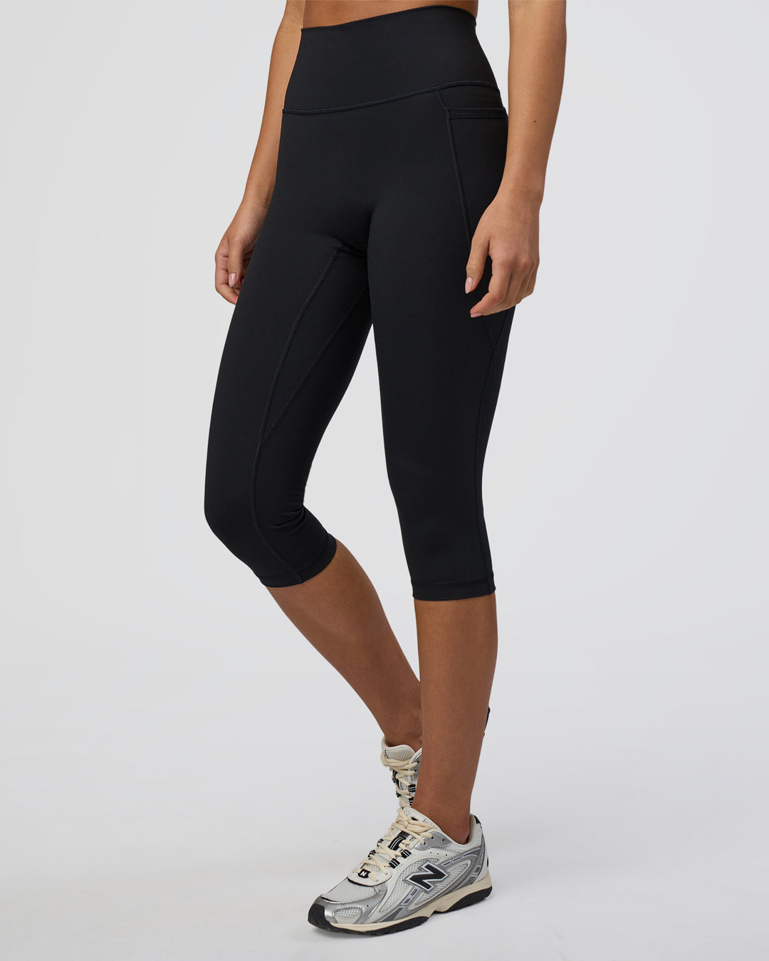 Woman wearing Fusion Ultra High-Rise 3/4 Legging Pockets - Black | Model:Eliza | Size:XS