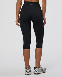 Woman wearing Fusion Ultra High-Rise 3/4 Legging Pockets - Black | Model:Eliza | Size:XS