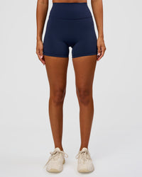 Woman wearing Fusion Ultra High-Rise 4" Short - Future Navy | Set:true | Angle:front | Model:Charli | Size:XS