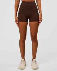 Woman wearing Fusion Ultra High-Rise 4" Short Pockets - Hot Chocolate | Set:true | Angle:front | Model:Charli | Size:XS