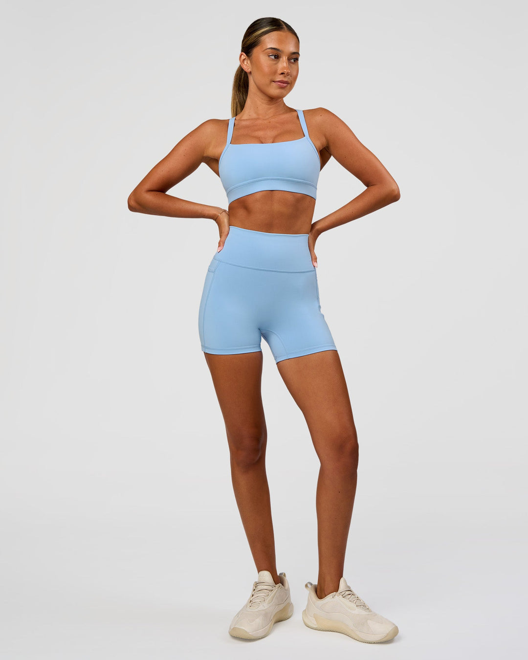 Woman wearing Fusion Ultra High-Rise 4" Short Pockets - Open Air | Model:Charli | Size:XS