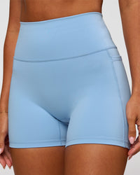 Woman wearing Fusion Ultra High-Rise 4" Short Pockets - Open Air | Model:Charli | Size:XS