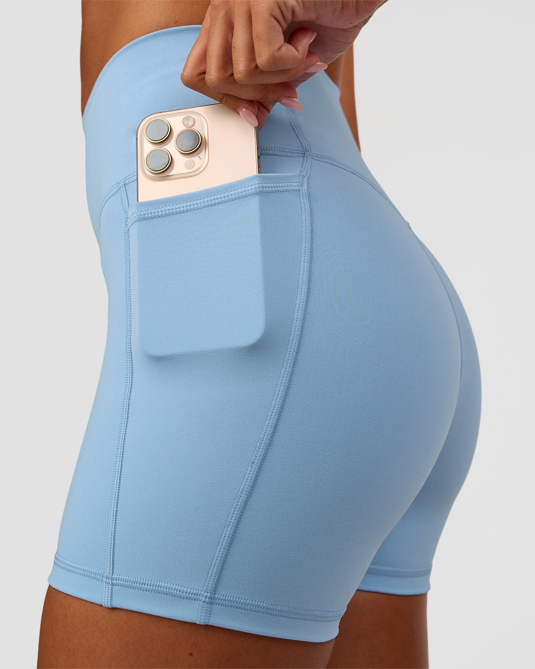 Woman wearing Fusion Ultra High-Rise 4" Short Pockets - Open Air | Set:true | Angle:closeup | Model:Charli | Size:XS