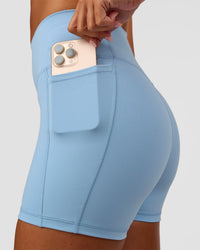 Woman wearing Fusion Ultra High-Rise 4" Short Pockets - Open Air | Set:true | Angle:closeup | Model:Charli | Size:XS