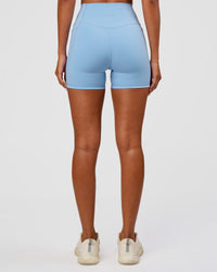 Woman wearing Fusion Ultra High-Rise 4" Short Pockets - Open Air | Set:true | Angle:back | Model:Charli | Size:XS