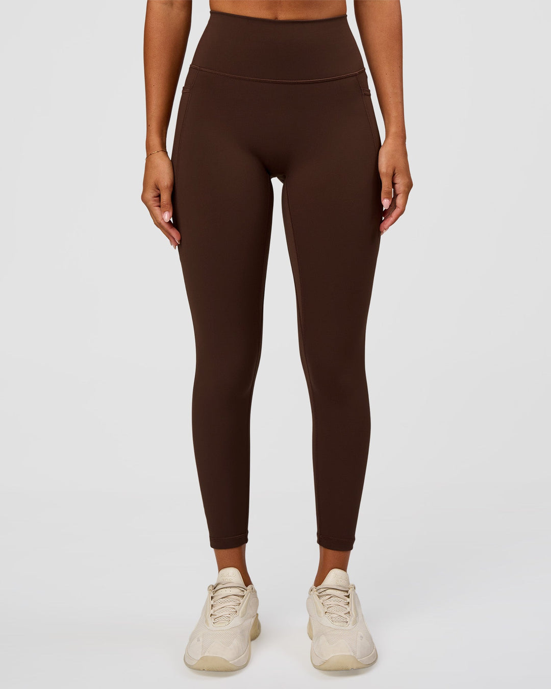 Woman wearing Fusion Ultra High-Rise 7/8 Legging Pockets - Hot Chocolate | Model:Charli | Size:XS