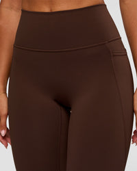 Woman wearing Fusion Ultra High-Rise 7/8 Legging Pockets - Hot Chocolate | Model:Charli | Size:XS