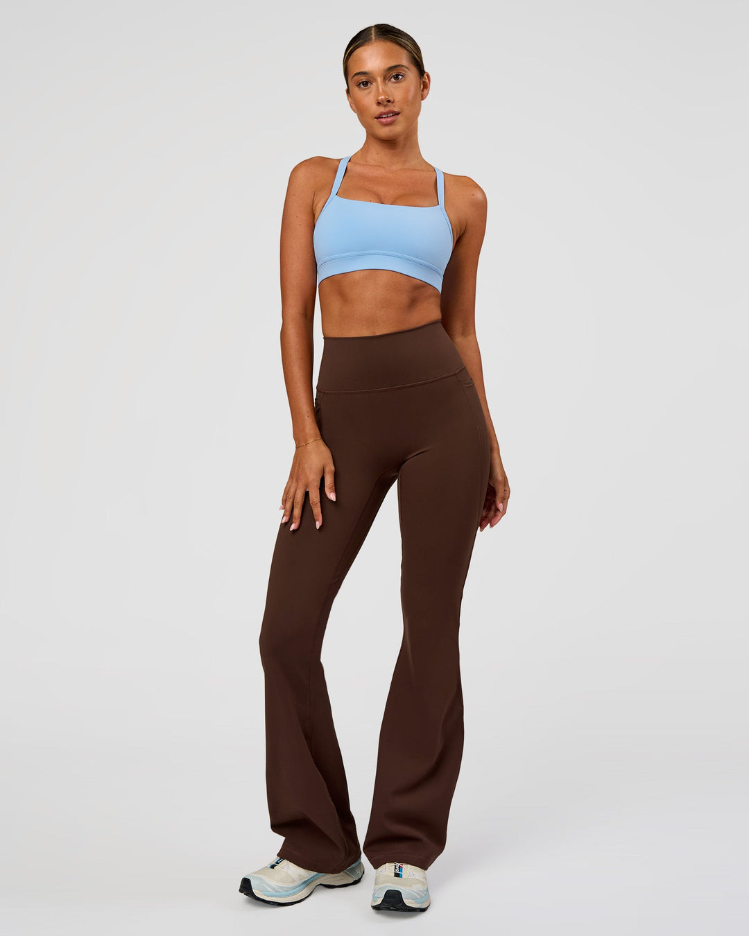 Woman wearing Fusion Ultra High-Rise Flared Legging Pockets - Hot Chocolate | Model:Charli | Size:XS