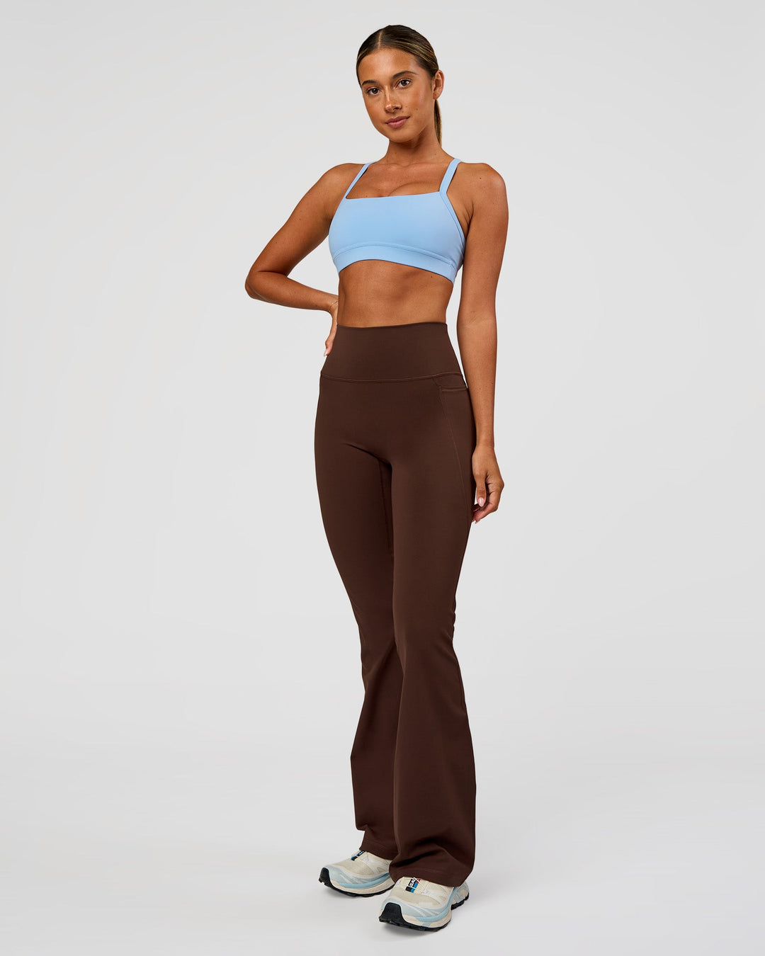 Woman wearing Fusion Ultra High-Rise Flared Legging Pockets - Hot Chocolate | Model:Charli | Size:XS