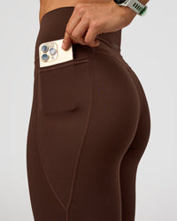 Woman wearing Fusion Ultra High-Rise Full Length Legging Pockets - Hot Chocolate | Model:Maja | Size:XS
