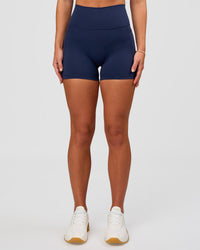 Woman wearing Fusion Ultra High-Rise 4" Short Pockets - Future Navy | Model:Issy | Size:XS