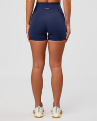 Woman wearing Fusion Ultra High-Rise 4" Short Pockets - Future Navy | Model:Issy | Size:XS