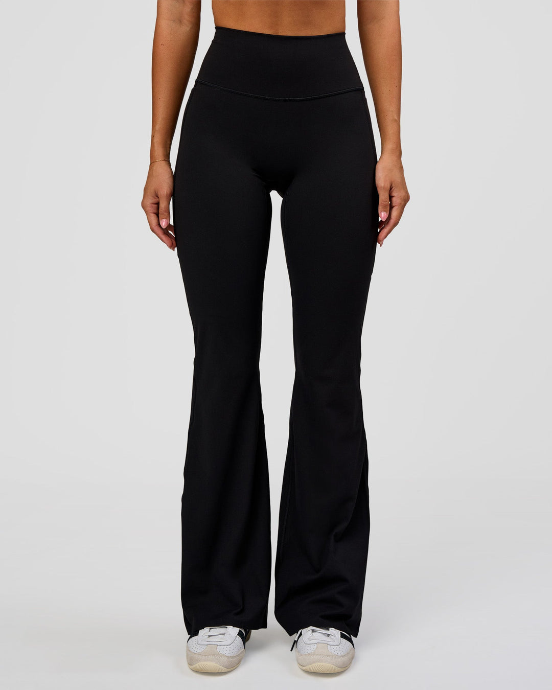 Woman wearing Fusion V-Contour High-Rise Flared Legging Pockets - Black | Model:Charli | Size:XS