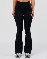 Woman wearing Fusion V-Contour High-Rise Flared Petite Legging Pockets - Black | Model:Issy | Size:XS